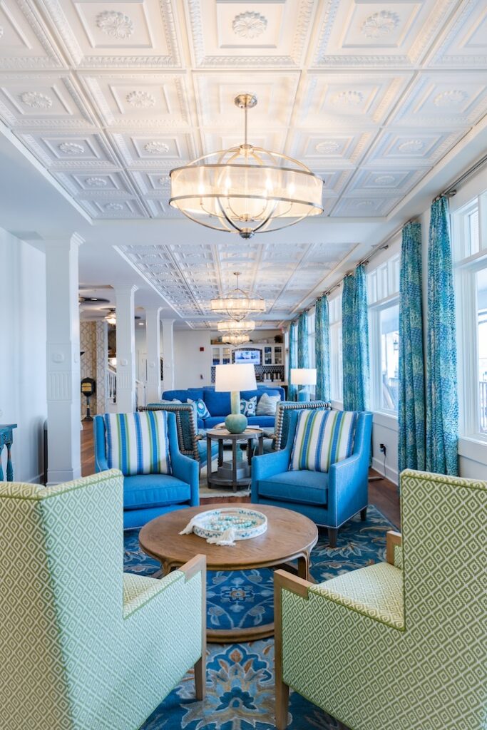 Lobby lounge with blue sofas, patterned rug, and decorative ceiling panels at Lake View Hotel.